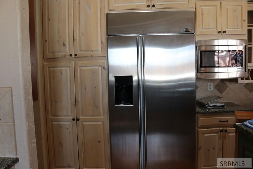 Refrigerator and microwave with kitchen cabinets