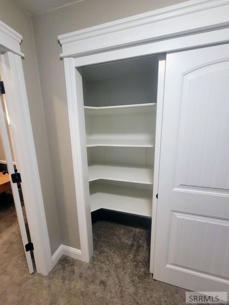 STORAGE CLOSET AT THE BOTTOM OF THE STAIRS