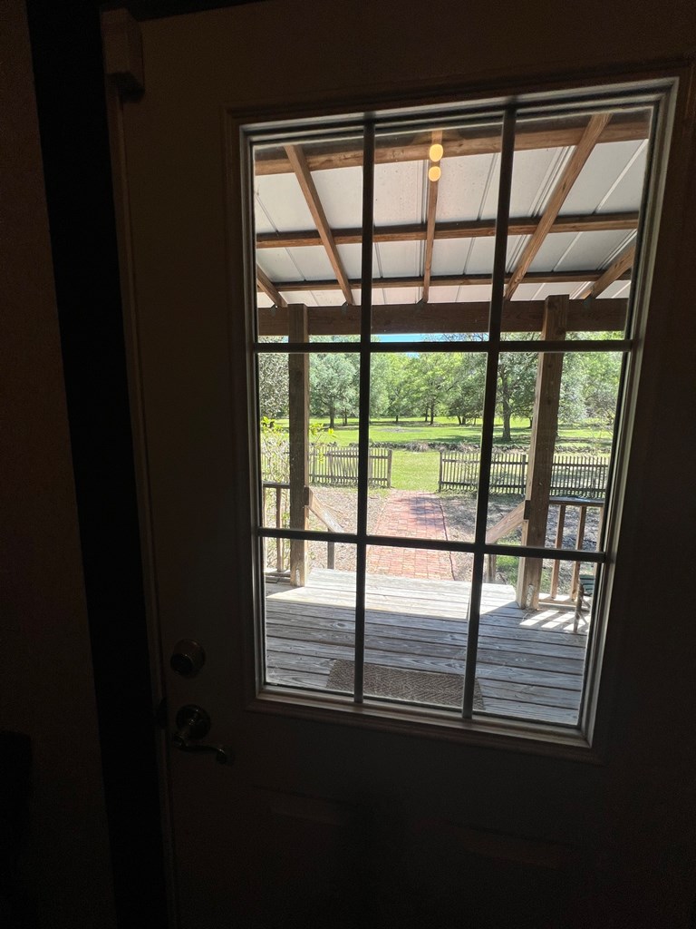 VIEW FROM INSIDE HOME TO FRONT PORCH AND PASTURE