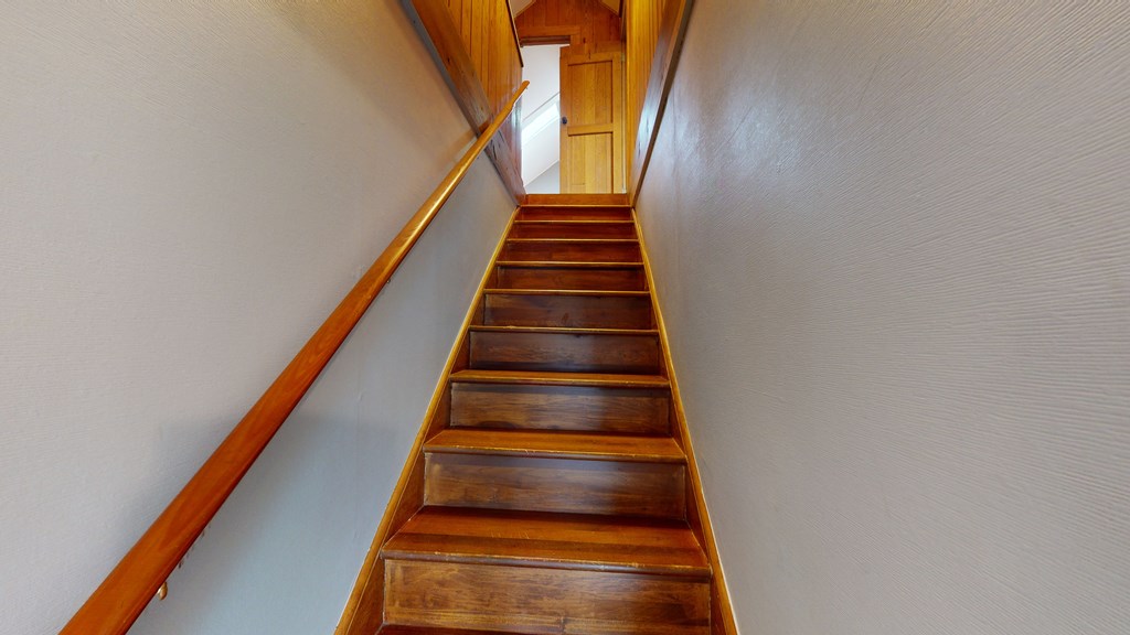 stairs leading to upper bedrooms and baths
